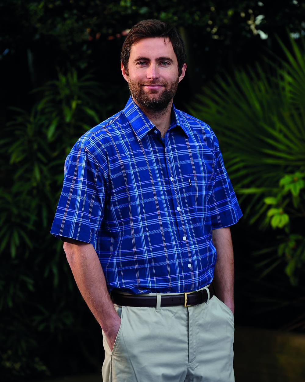 Blue Coloured Champion Whitby Short Sleeved Shirt On A Garden Background