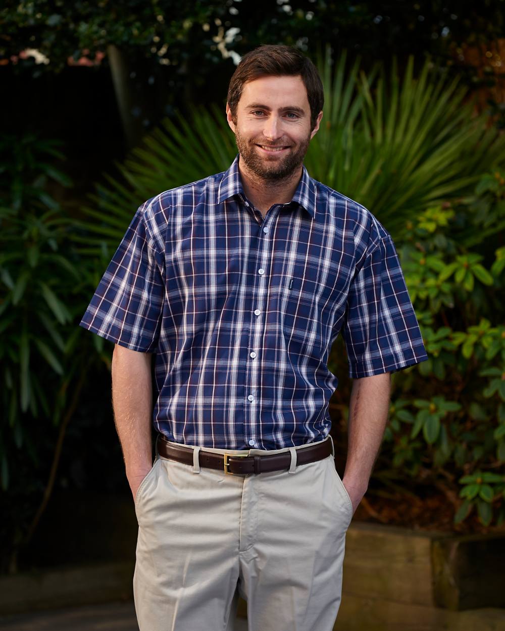 Navy Coloured Champion Whitby Short Sleeved Shirt On A Garden Background