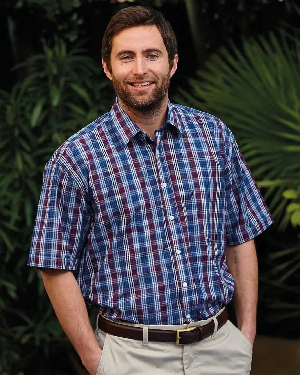 Red Coloured Champion Whitby Short Sleeved Shirt On A Garden Background