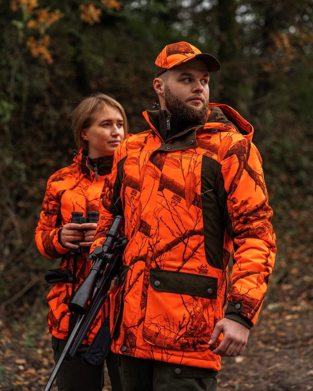 Realtree Edge Orange Coloured Deerhunter Eagle Cap On A Forest Background