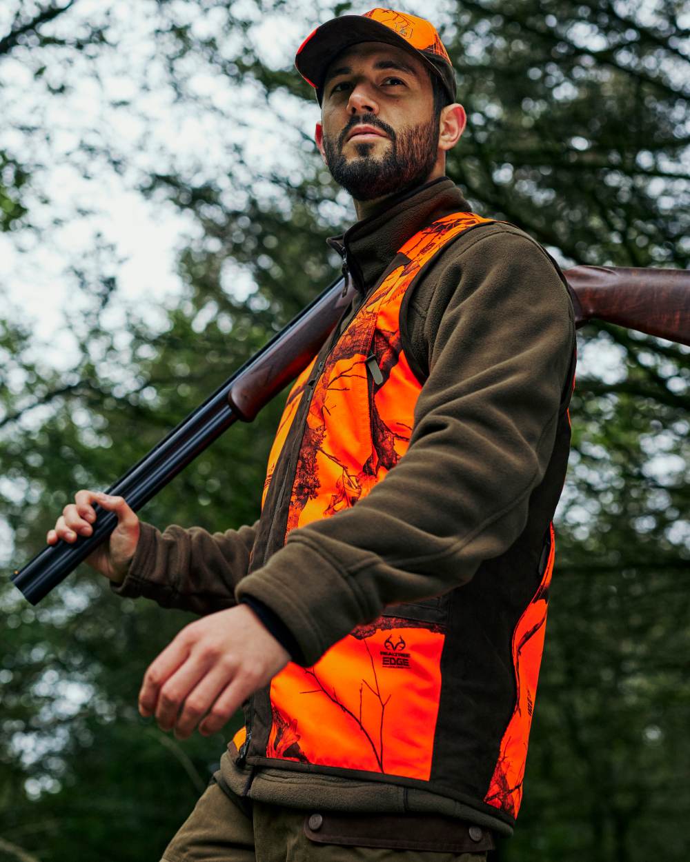 Realtree Edge Orange Coloured Deerhunter Eagle Cap On A Forest Background