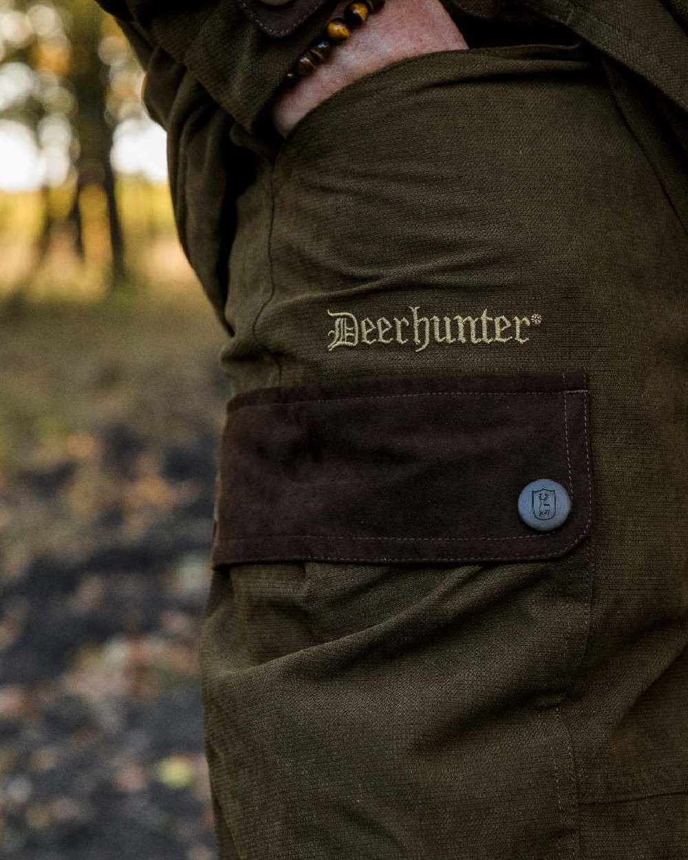 Tarmac Green coloured Deerhunter Eagle Trouser on a blurry background