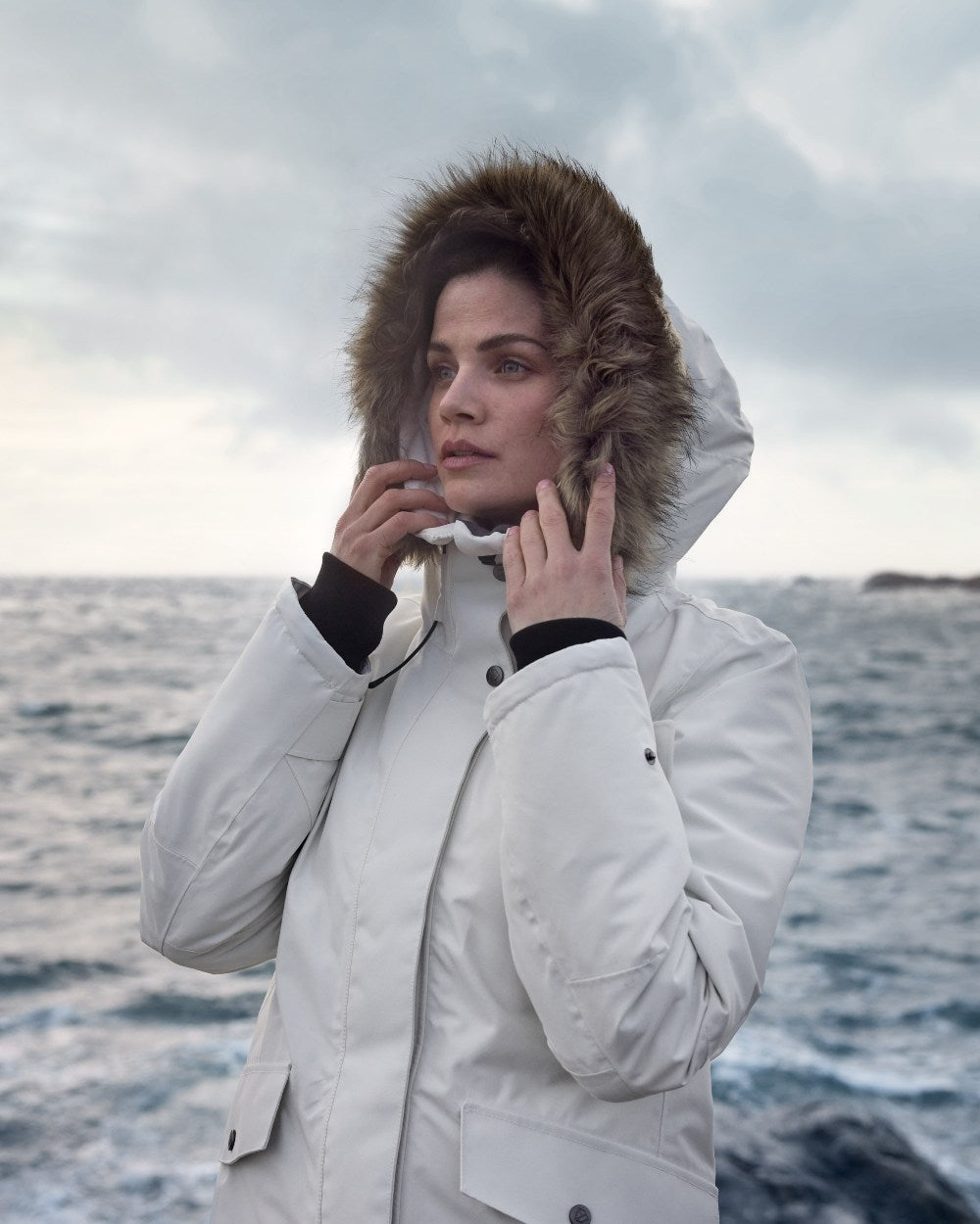 White Foam Coloured Didriksons Erika Ladies Padded Waterproof Parka 3 On A Coastal Background