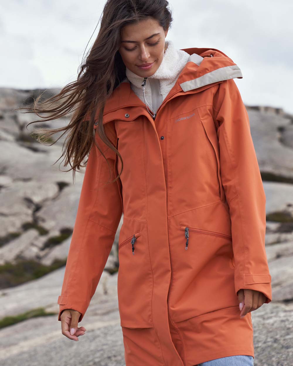 Brique Red coloured Didriksons Womens Parka on Ocean  background 