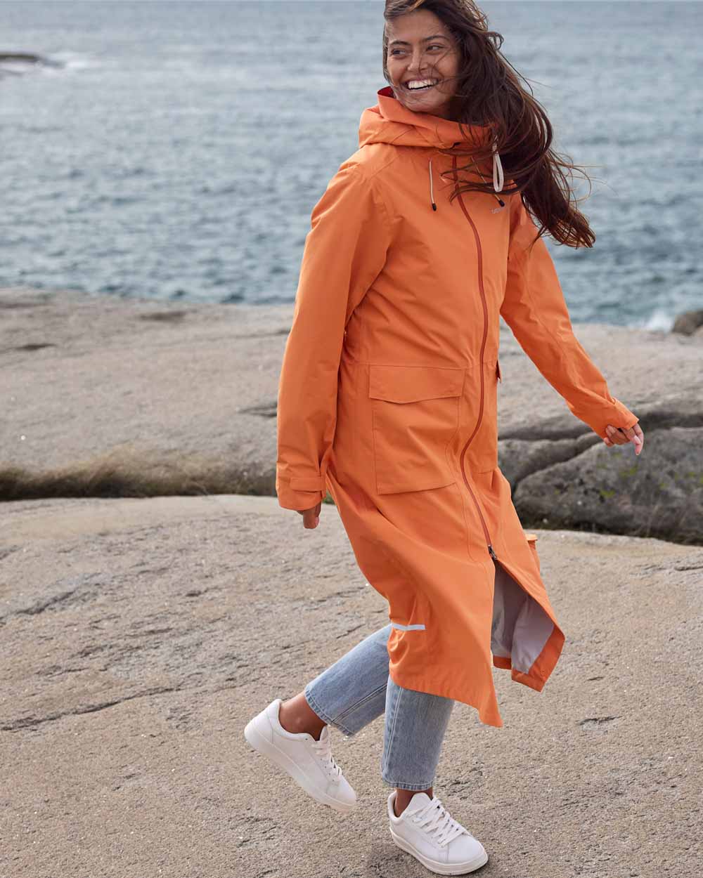 Faded Brique coloured Didriksons Nadja Parka on Ocean background 
