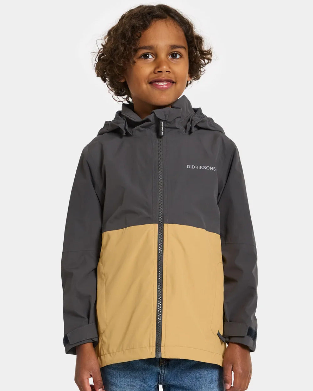 Sanstorm Coloured Didriksons Piko Childrens Jacket On A Grey Background 
