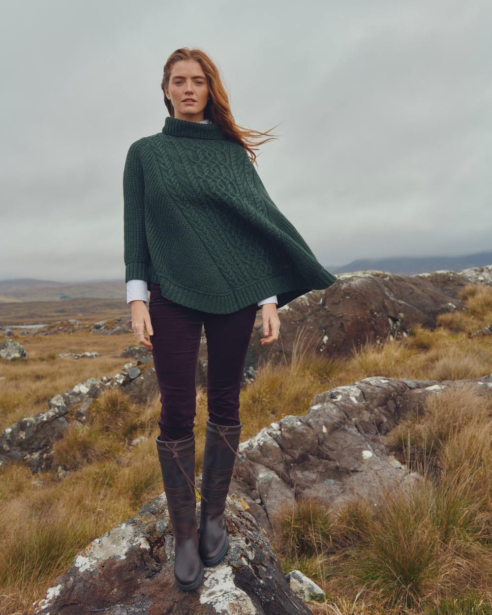 Olive Coloured Dubarry Womens Kilronan Merino Poncho On A Hill Background