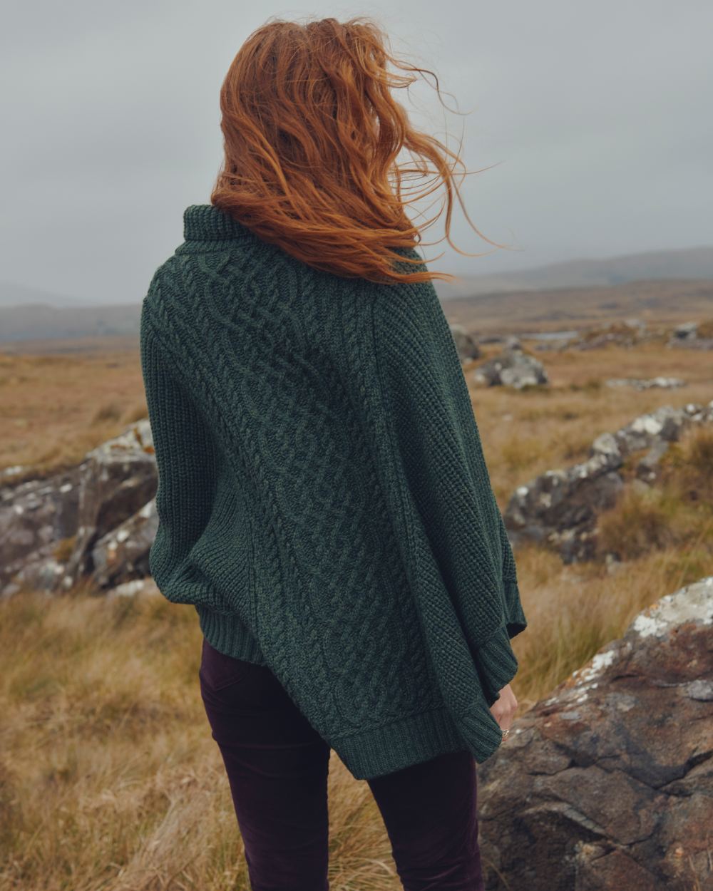 Olive Coloured Dubarry Womens Kilronan Merino Poncho On A Hill Background