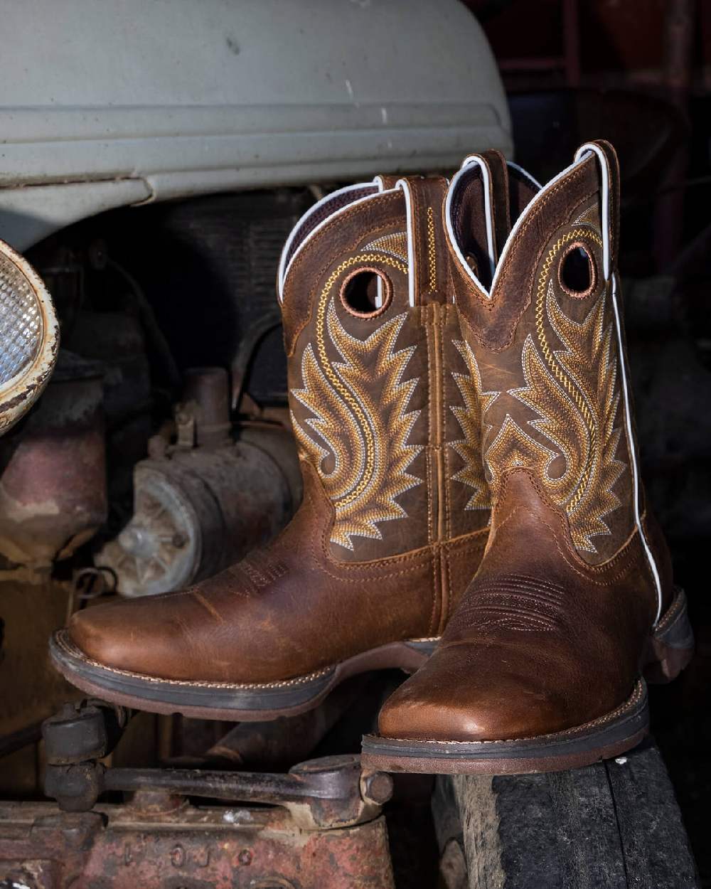 Saddle Brown Coloured Durango Mens DDB0377 Rebel Western Boots on Car Background