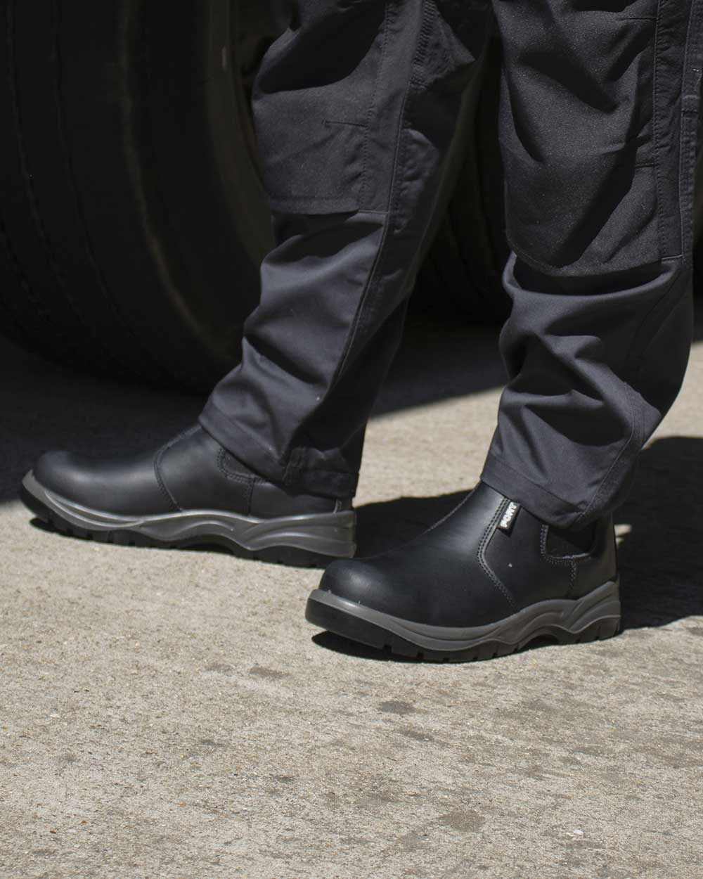 Black Coloured Fort Nelson Safety Dealer Boots On A Street Background