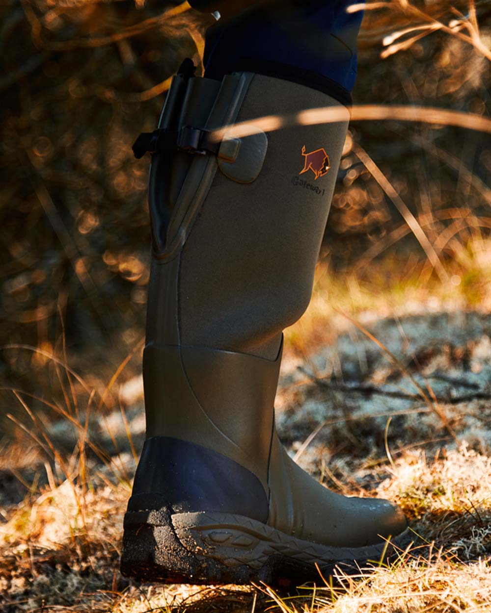Khaki coloured Gateway1 Woodwalker 18" 4mm Wellingtons on Trail background
