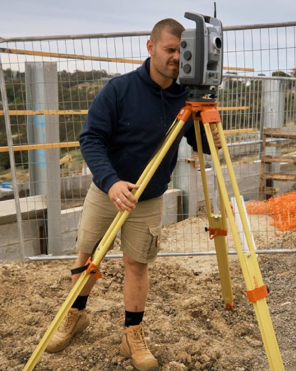 Navy Coloured Hard Yakka Mens Brushed Fleece Hoodie on Construction Background
