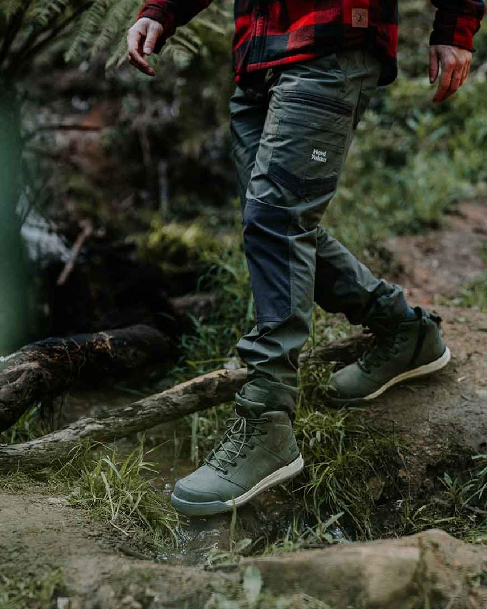 Military Green Coloured Hard Yakka Mens Raptor Active Trousers on Forest Background