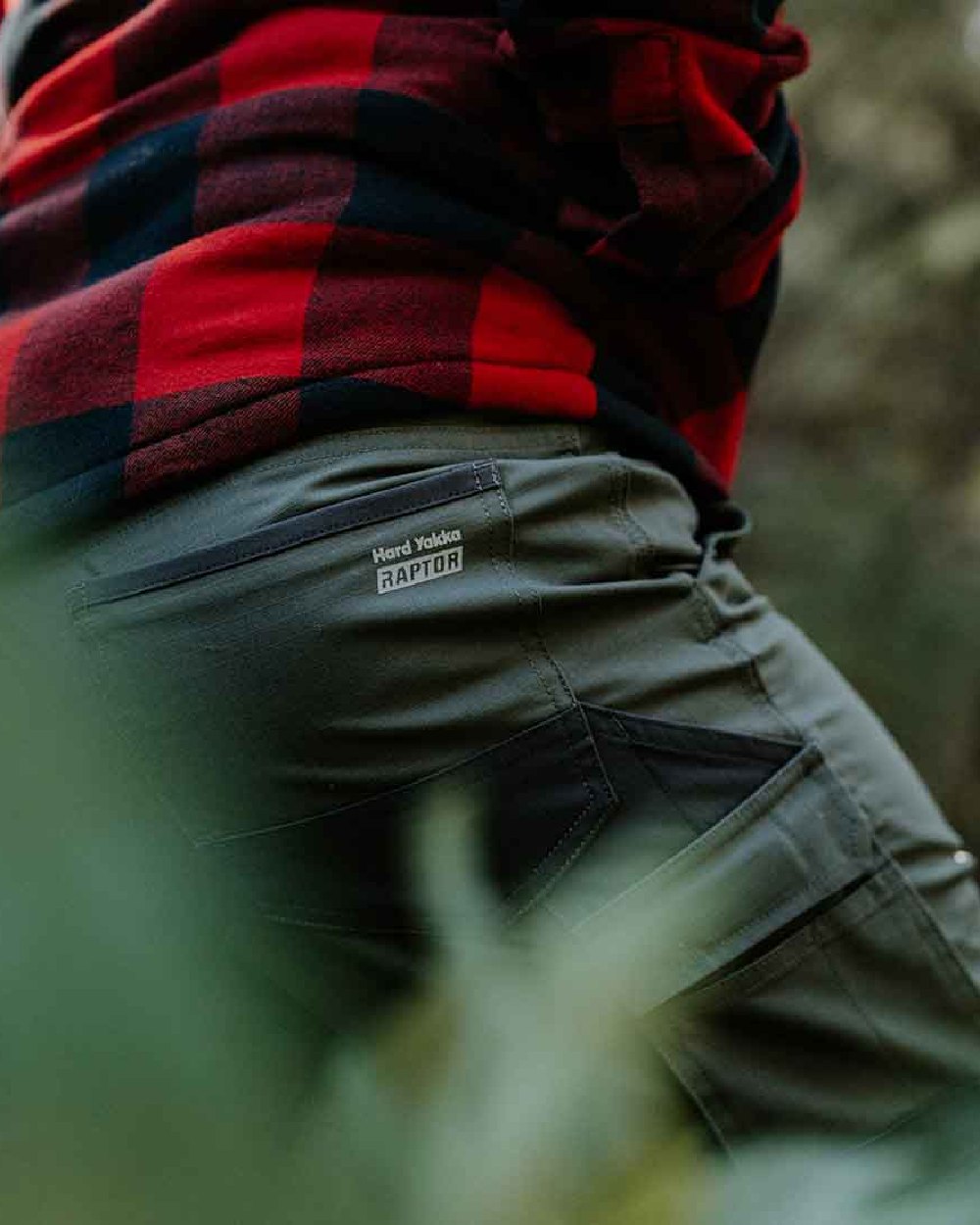 Military Green Coloured Hard Yakka Mens Raptor Active Trousers on Forest Background