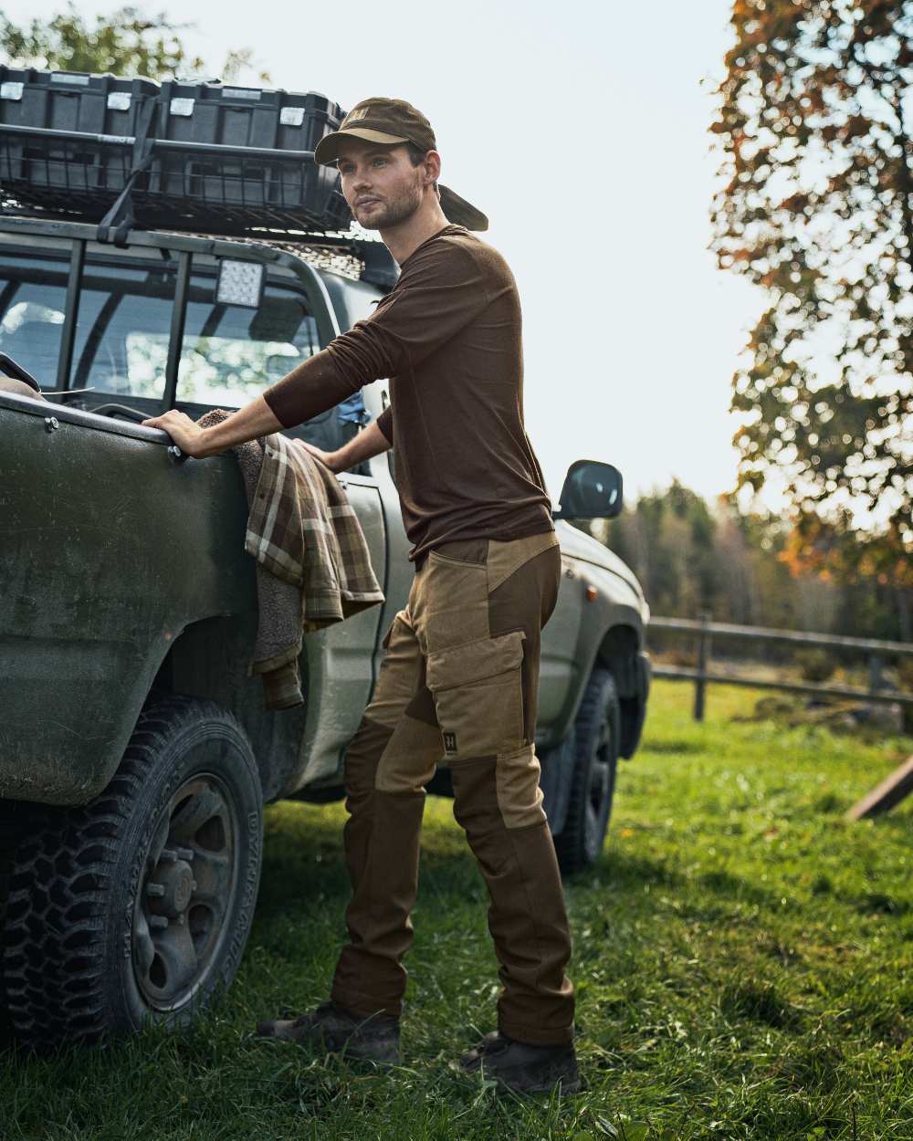 Willow Green Coloured Harkila Base All Season Long Sleeve T-Shirt On A Backyard Background