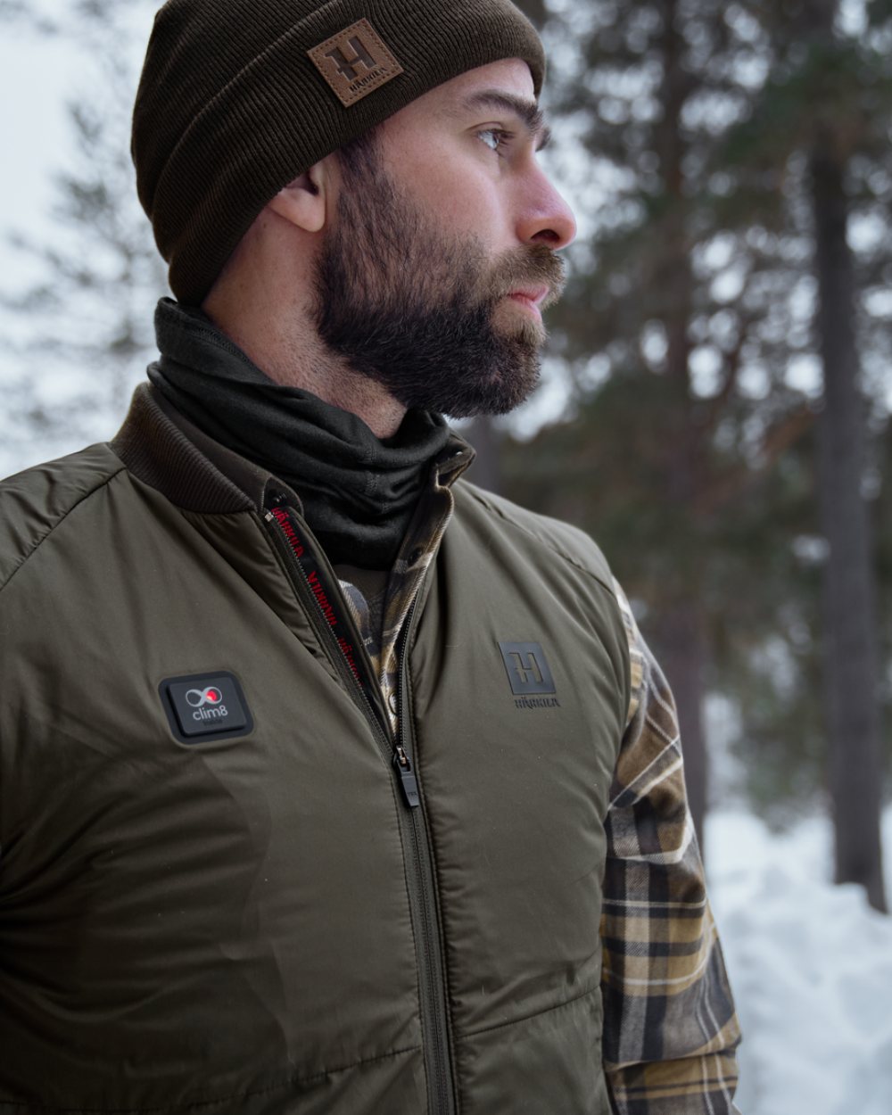 Willow Green Coloured Harkila Clim8 Base Waistcoat on snow background