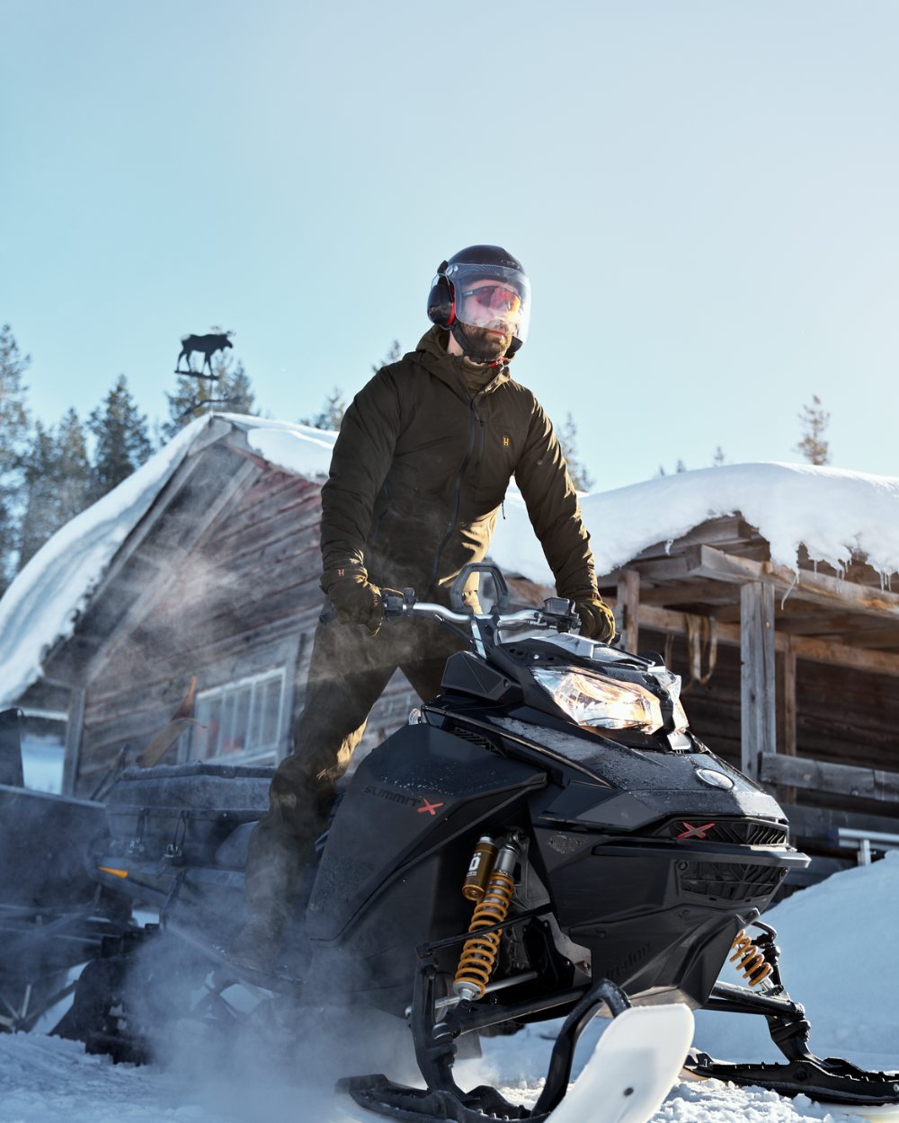 Willow Green Coloured Harkila Logmar HWS Packable Jacket on snow background