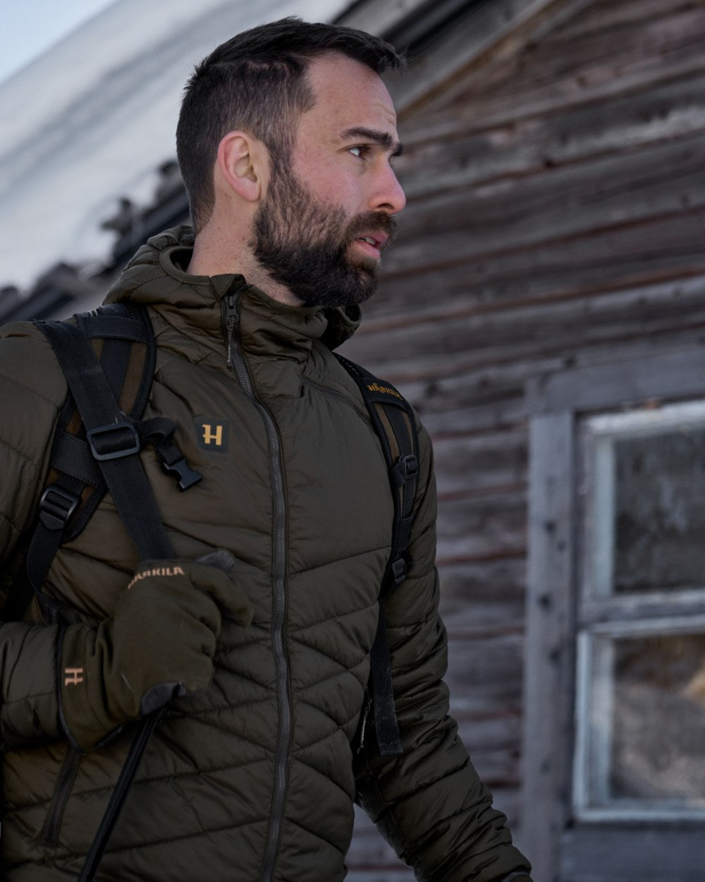 Willow Green Coloured Harkila Logmar Insulated Packable Hooded Jacket on snow background