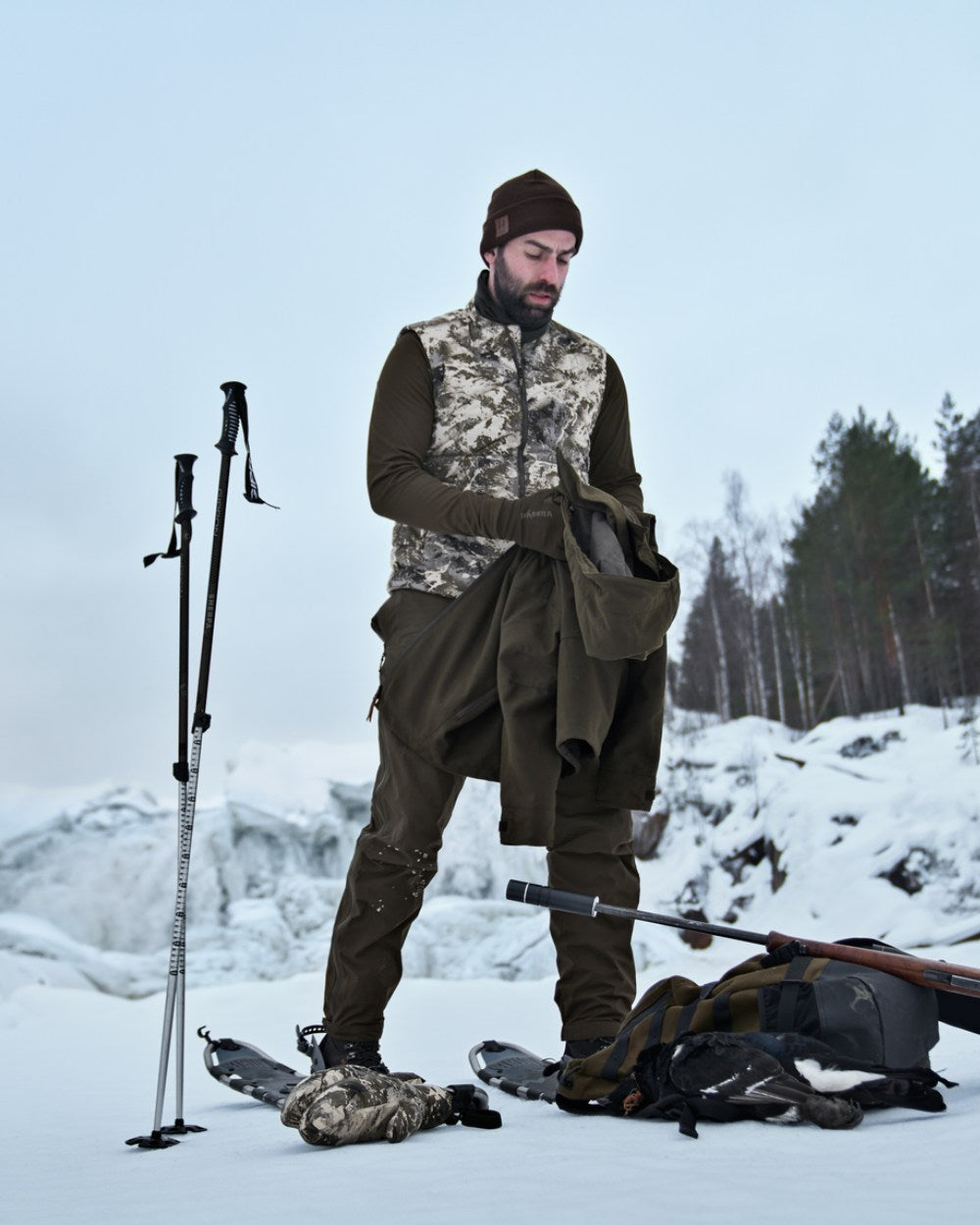 AXIS Mountain Coloured Harkila Camo HSP Insulated Waistcoat on snow background