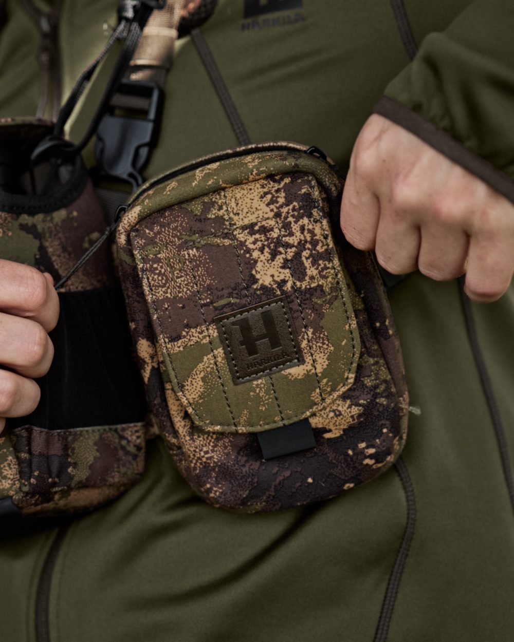 AXIS MSPForest Coloured Harkila Utility Camo Pouch on blurry background