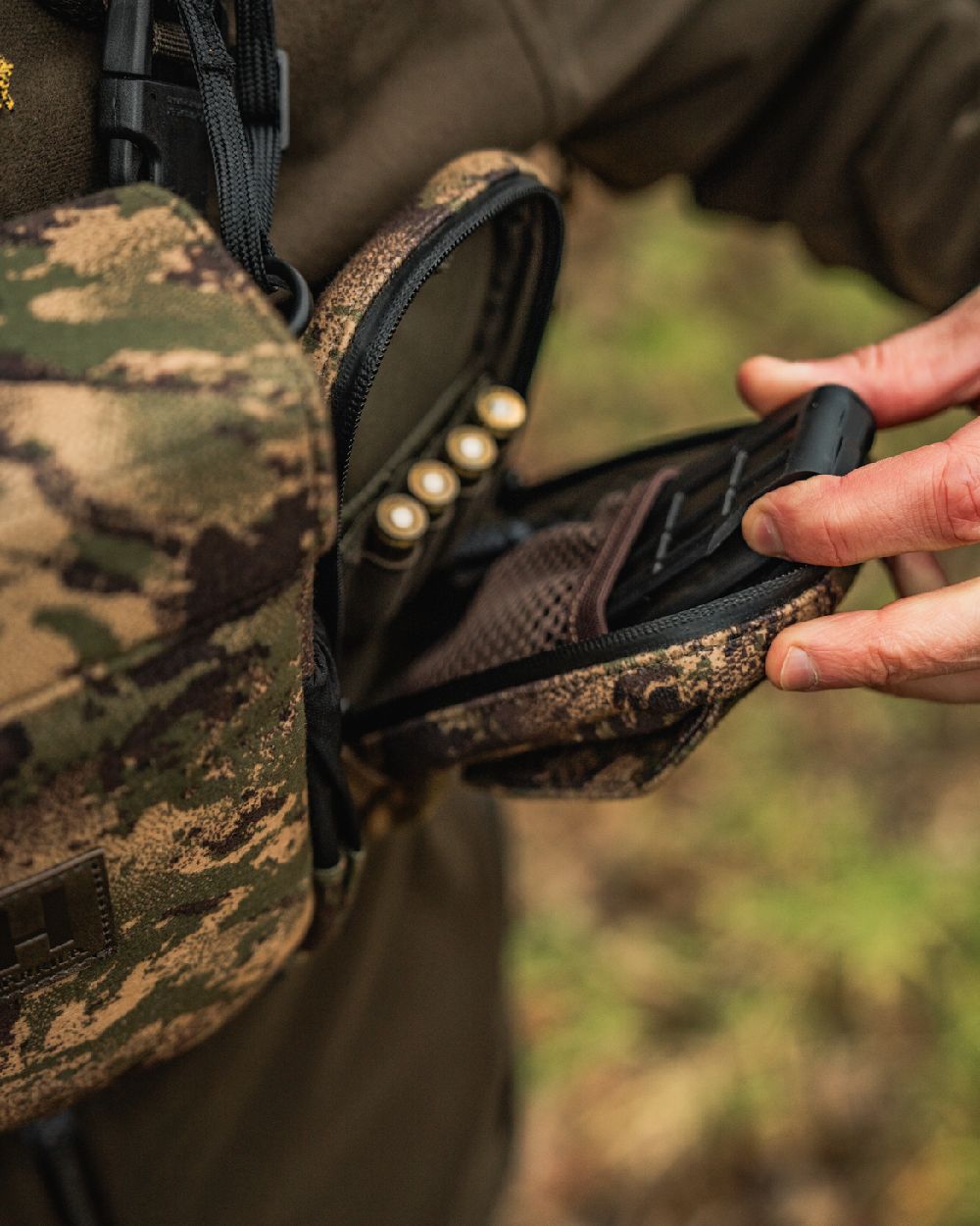 AXIS MSPForest Coloured Harkila Utility Camo Pouch on blurry background