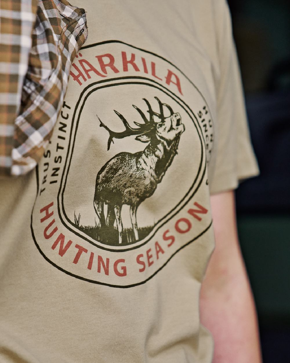 Sand Coloured Harkila Womens Stag Badge Short Sleeve T-Shirt on blurry background