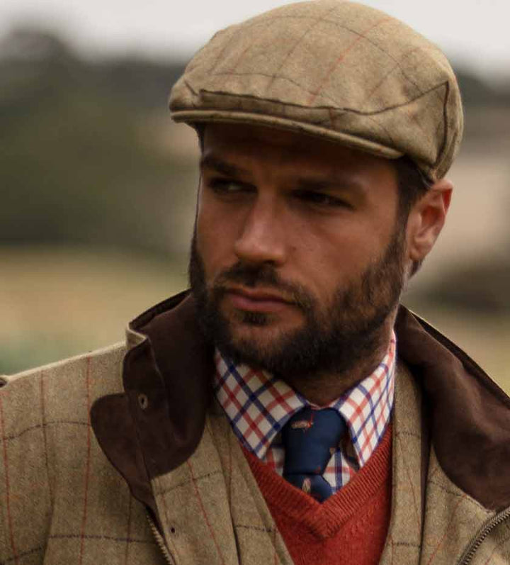 Men's Hats and Caps. Man wears Light green tweed flat cap with shirt and tie.