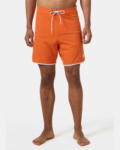 Flame coloured Helly Hansen Mens HP 7 inch Curve Board Shorts on grey background 