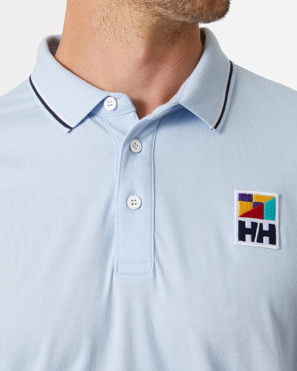 Pinnacle Blue coloured Helly Hansen Mens Jersey Polo Shirt on grey background 