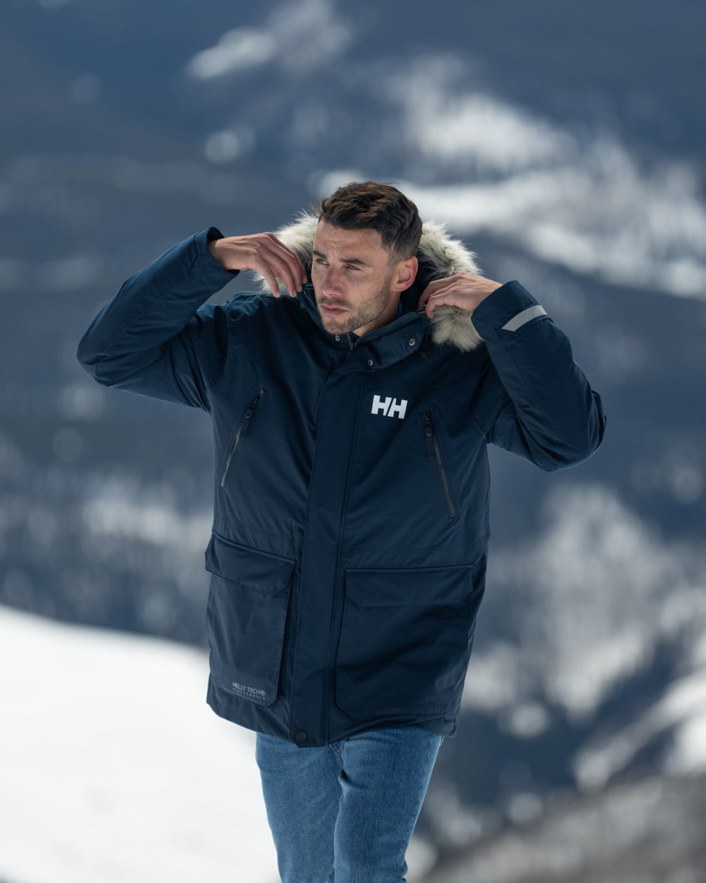 Navy Coloured Helly Hansen Mens Reine Winter Parka on Outdoor Background