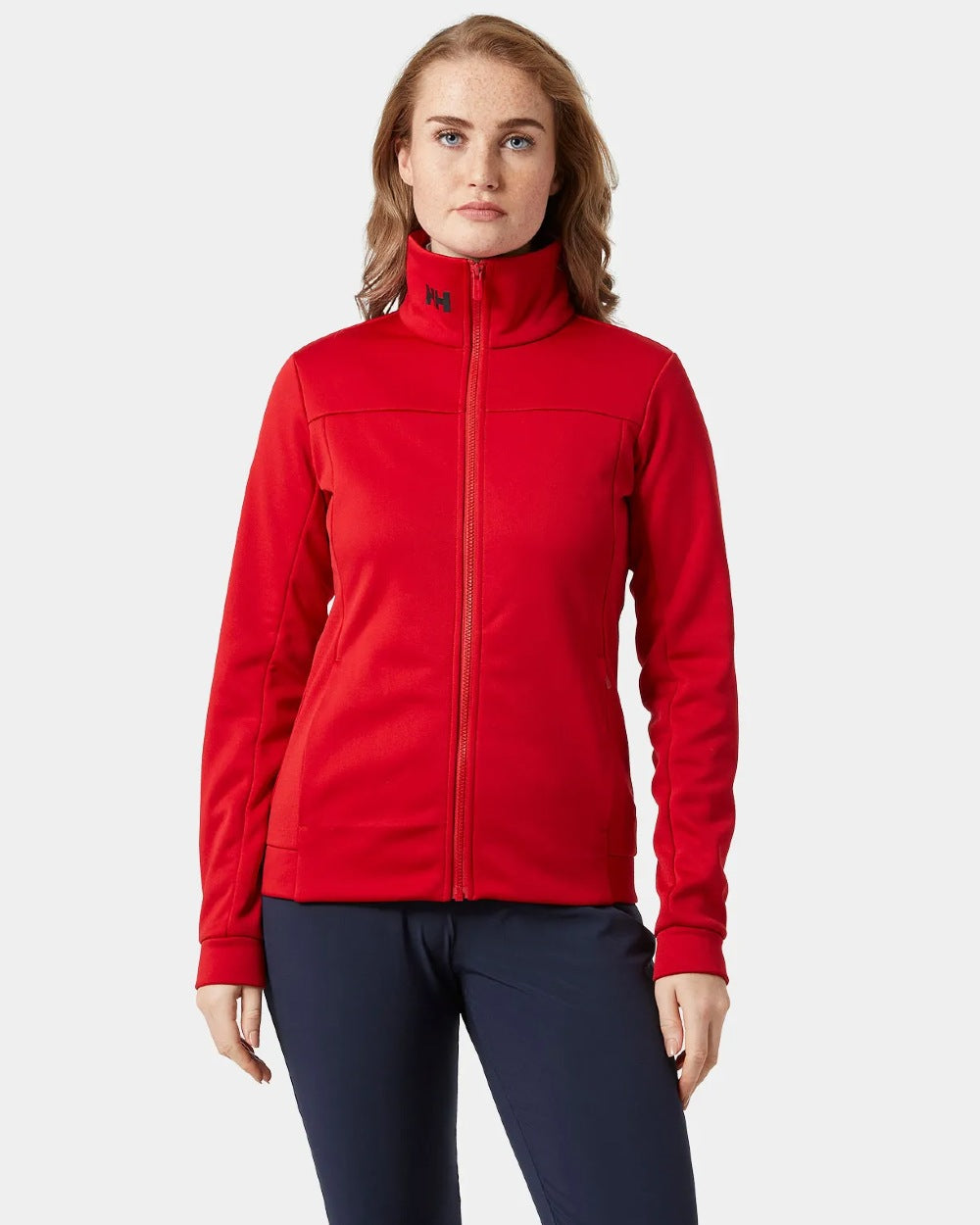 Red coloured Helly Hansen Womens Crew Fleece Jacket on grey background