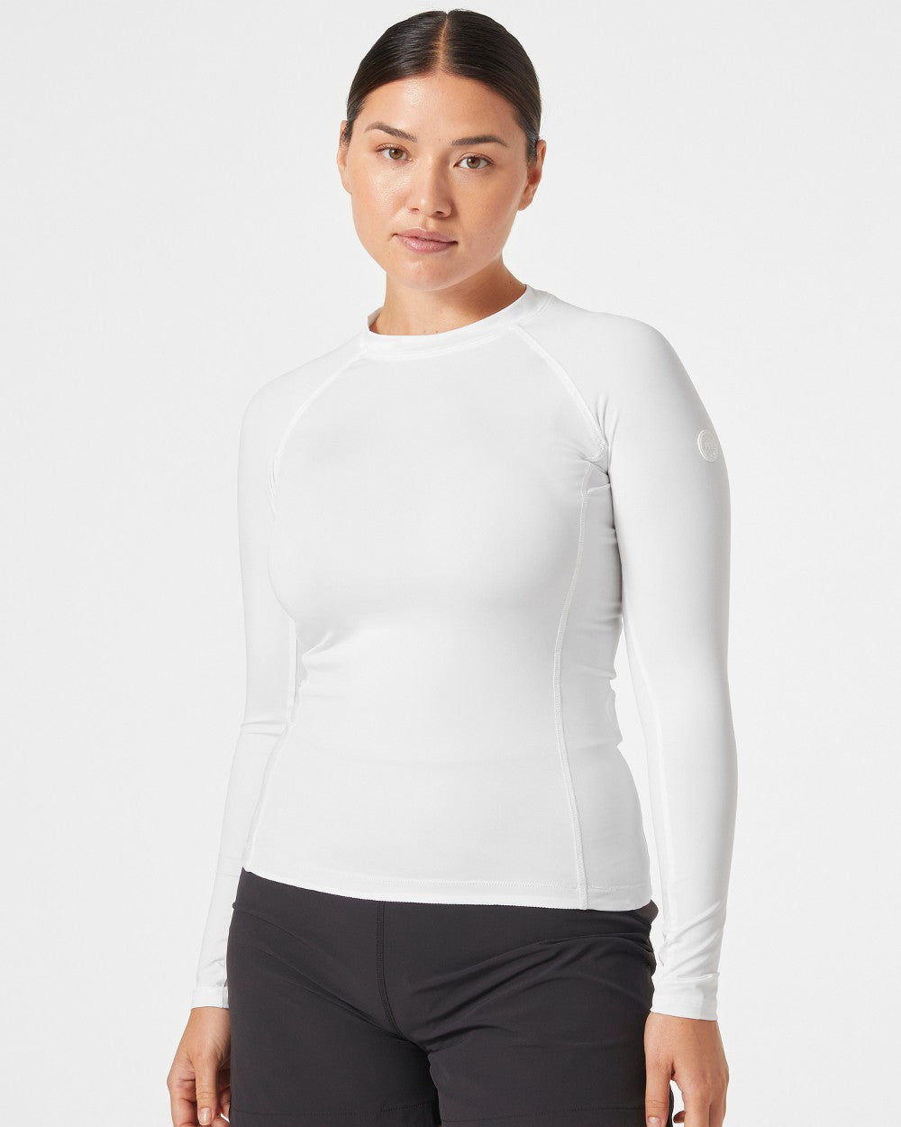 White coloured Helly Hansen Womens Waterwear Rashguard on grey background 