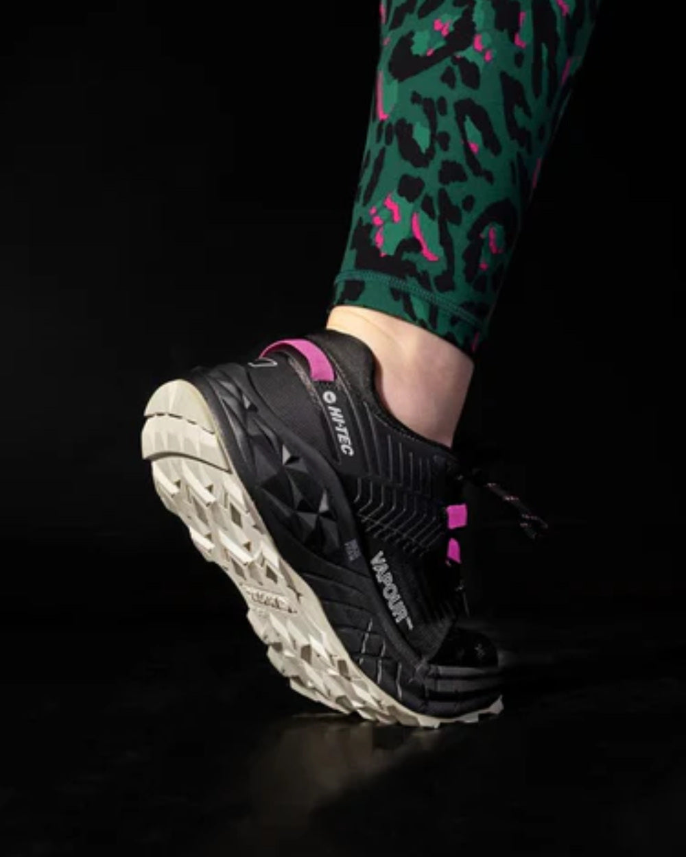Black Coloured Hi-Tec Womens Fuse Trail Low Trainers On A Black Background