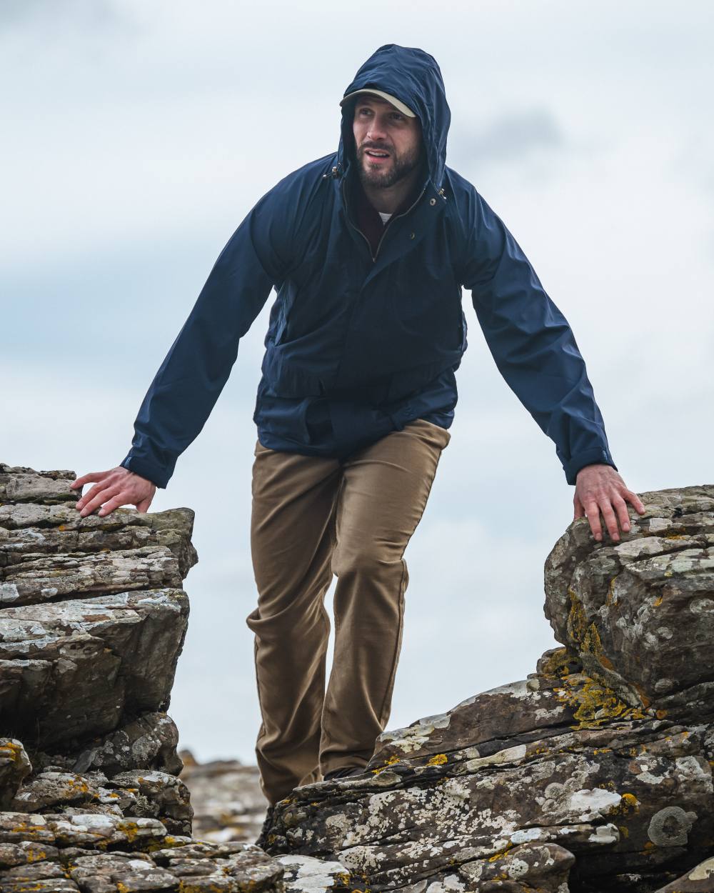 Navy coloured Hoggs of Fife Culloden Waterproof Field Jacket on mountain background 