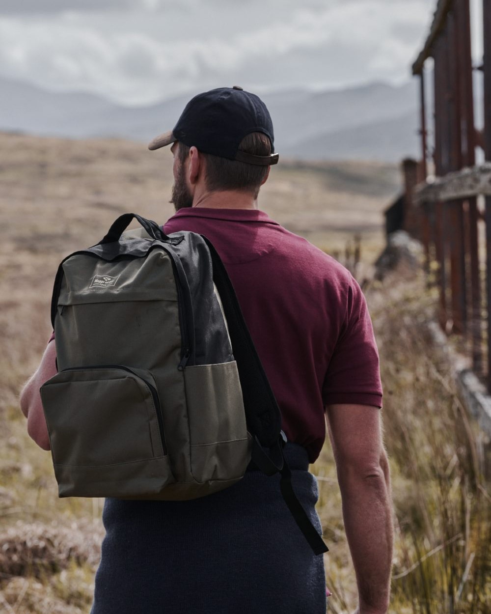 Green Black Coloured Hoggs of Fife Field & Trek Backpack on mountain background