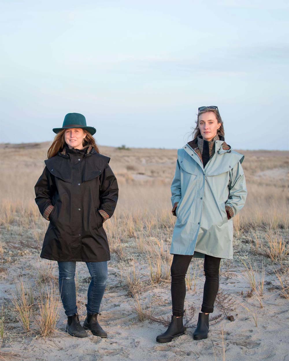 Black coloured Jack Murphy Cotswold Ladies Waterproof 3/4 Coat on Beach background