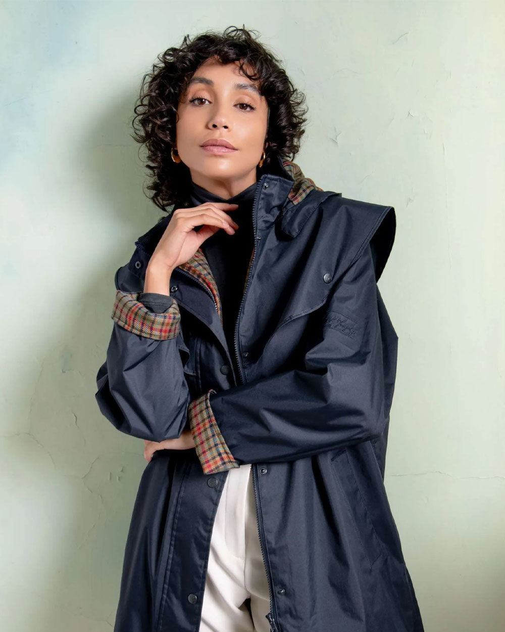Heritage Navy coloured Jack Murphy Cotswold Ladies Waterproof 3/4 Coat on wall background