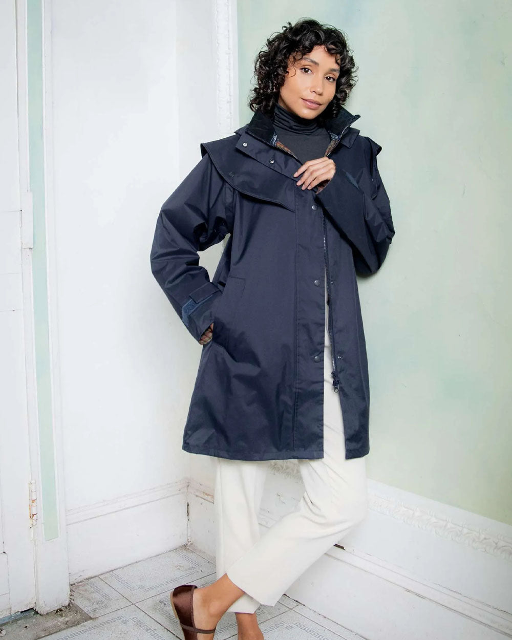 Heritage Navy coloured Jack Murphy Cotswold Ladies Waterproof 3/4 Coat on wall background