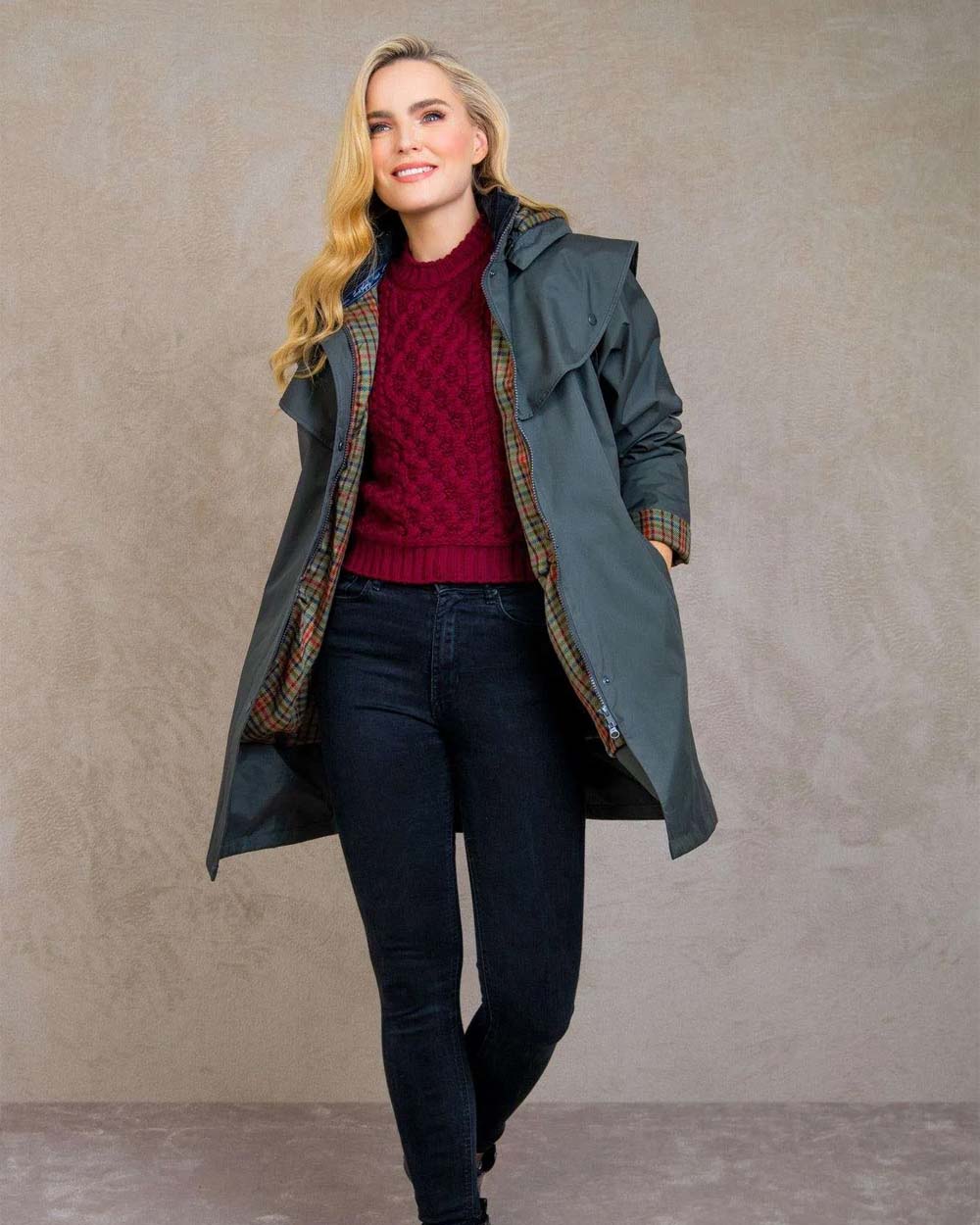 Olive coloured Jack Murphy Cotswold Ladies Waterproof 3/4 Coat on wall background