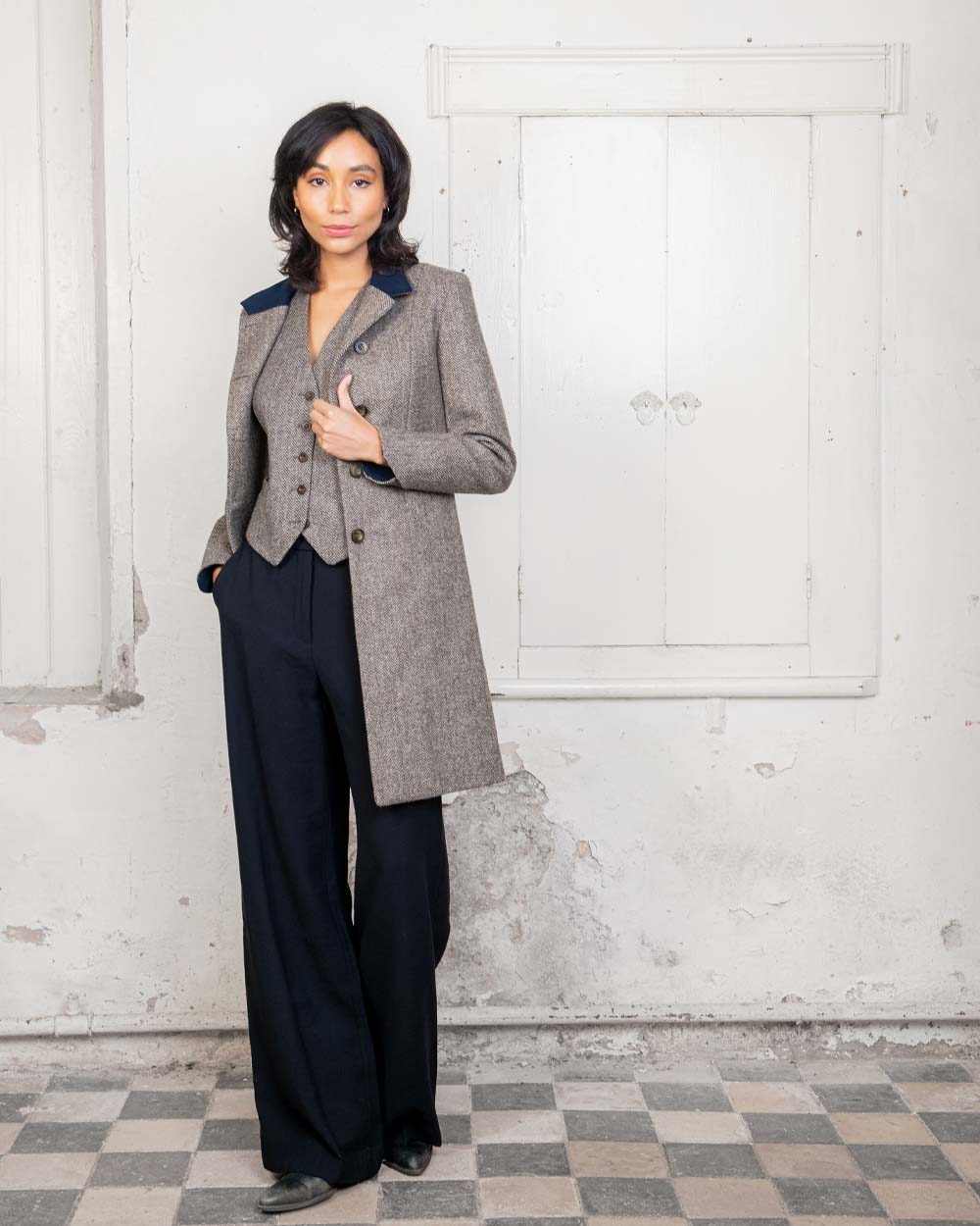 Light Tan Herringbone coloured Jack Murphy Isabella Tweed Coat on Urban background