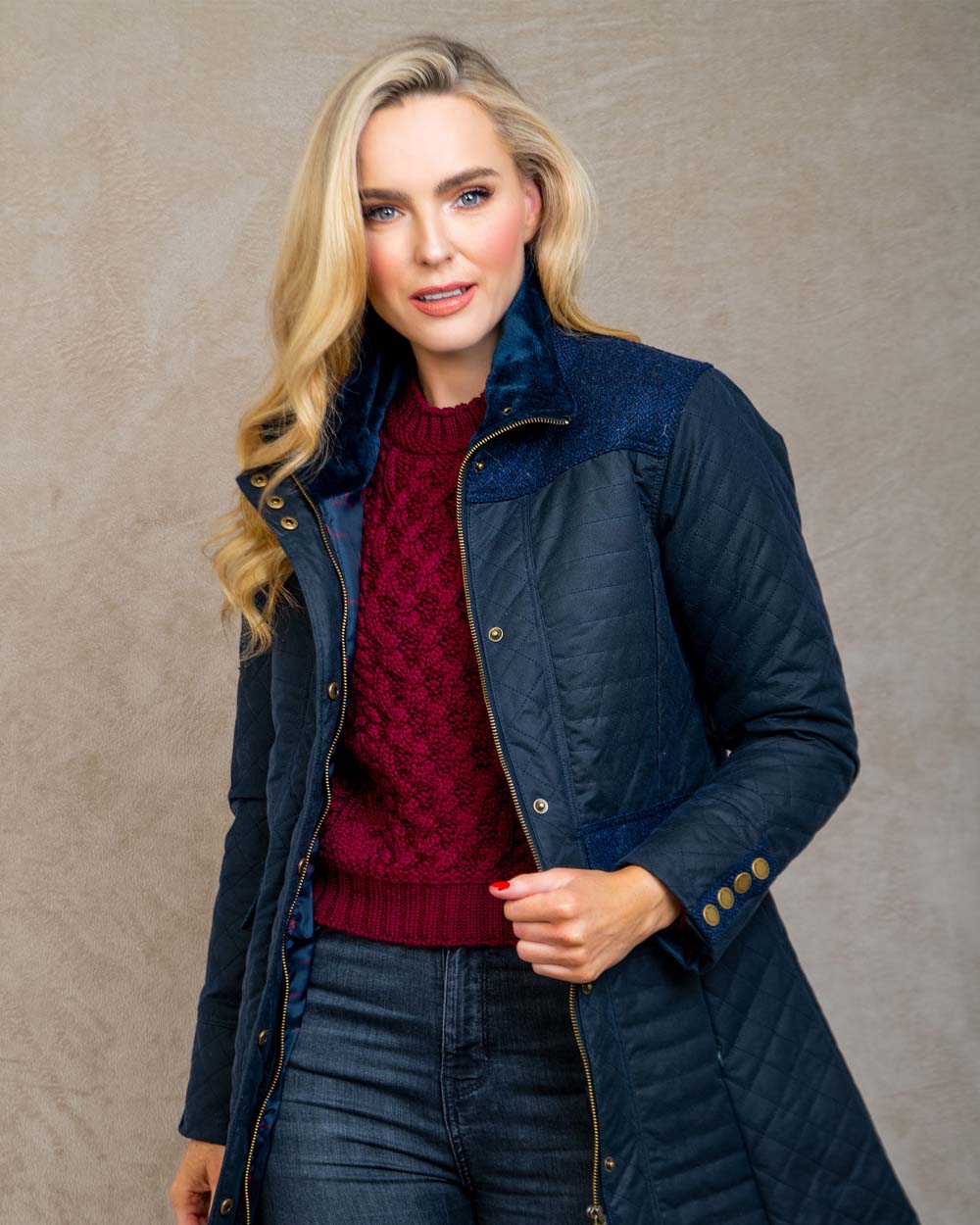 Navy coloured Jack Murphy Jodie Wax Coat on Pastel background