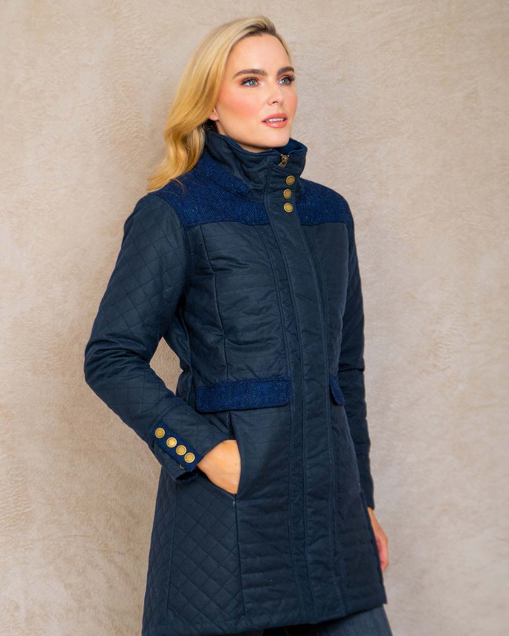 Navy coloured Jack Murphy Jodie Wax Coat on Pastel background