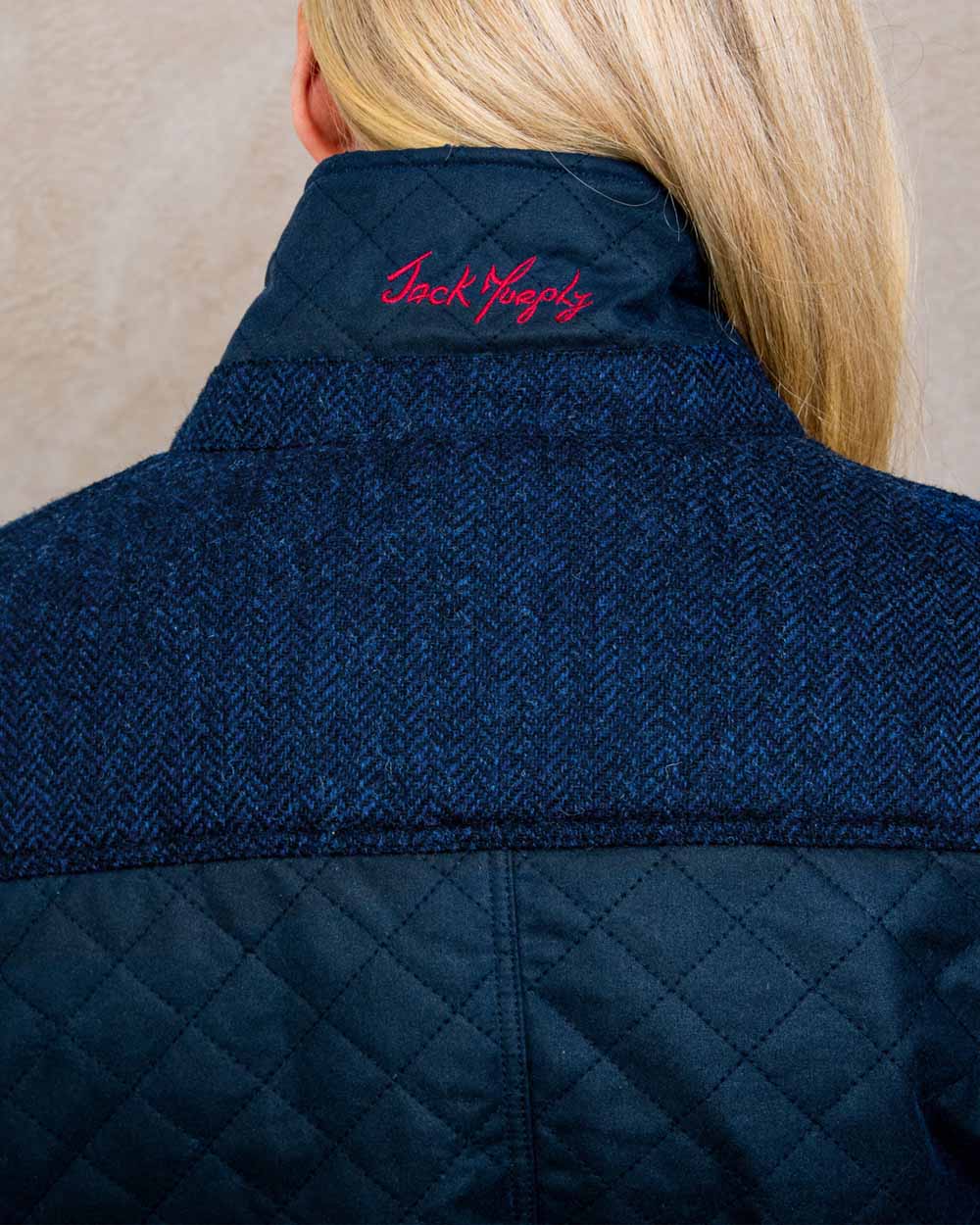 Navy coloured Jack Murphy Jodie Wax Coat on Pastel background