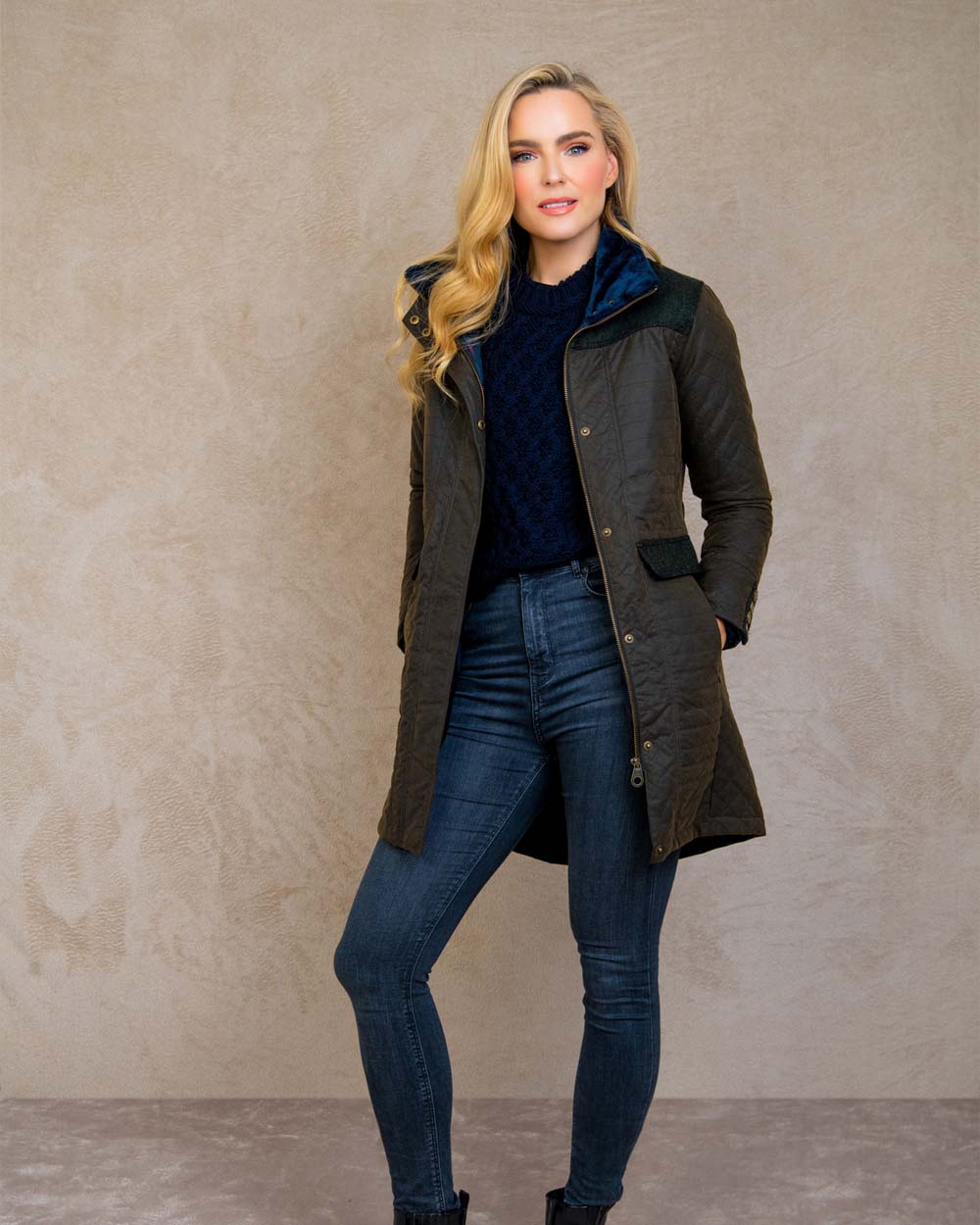 Olive coloured Jack Murphy Jodie Wax Coat on Pastel background