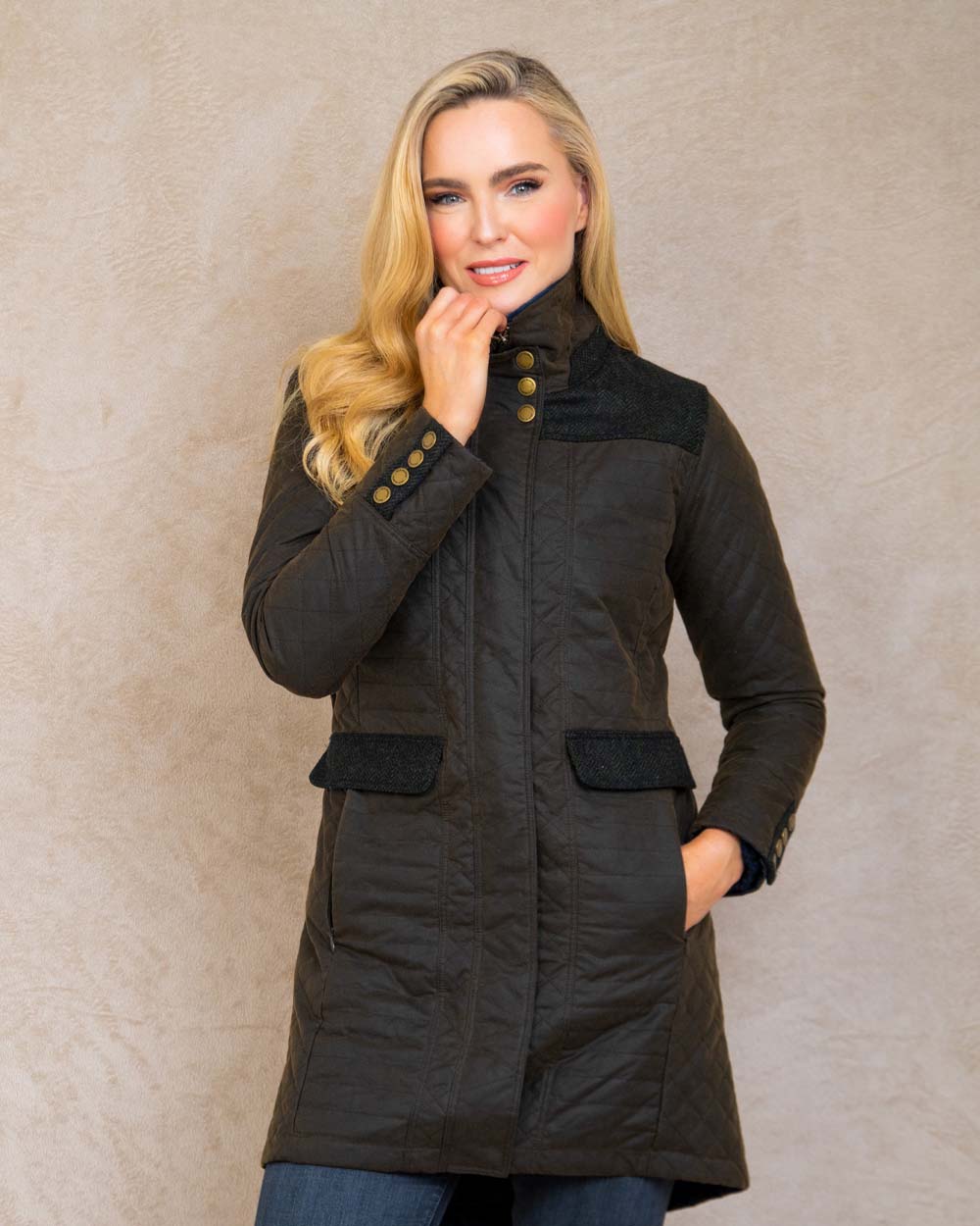 Olive coloured Jack Murphy Jodie Wax Coat on Pastel background