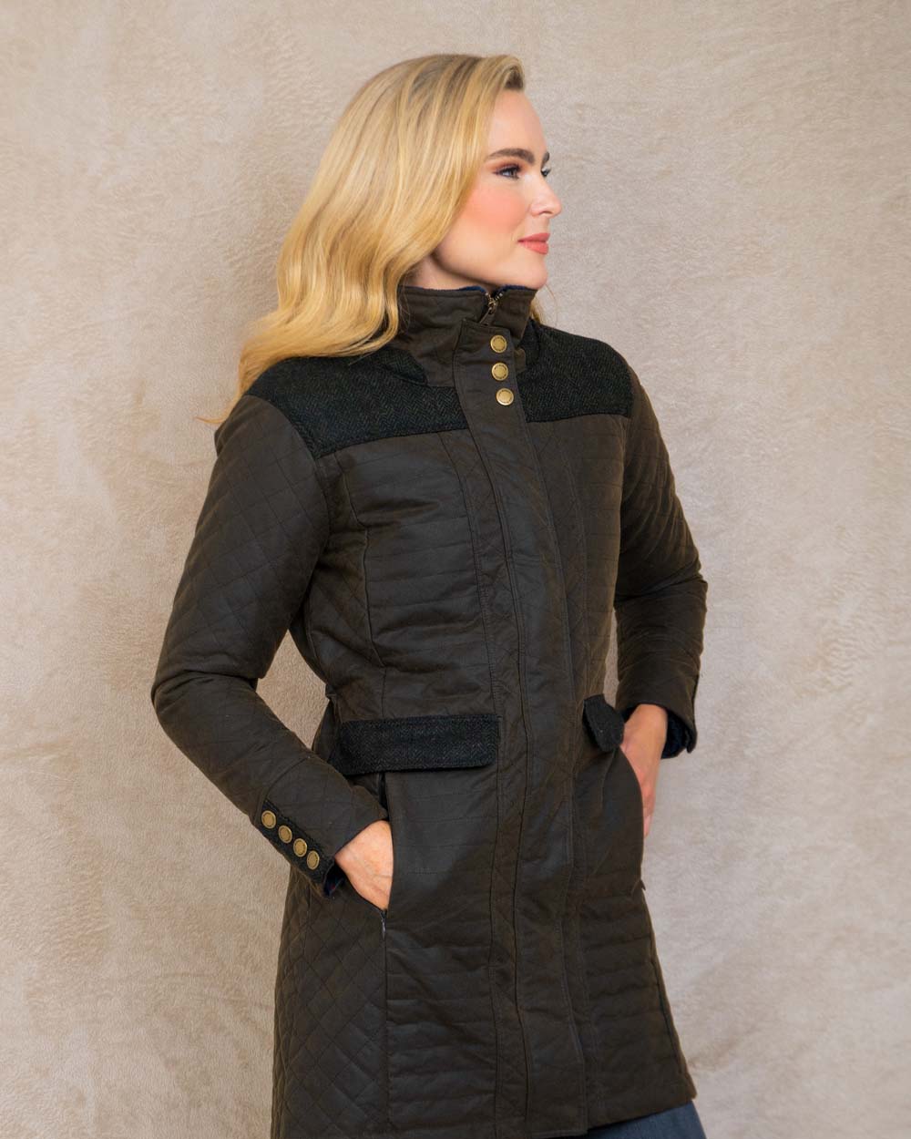 Olive coloured Jack Murphy Jodie Wax Coat on Pastel background