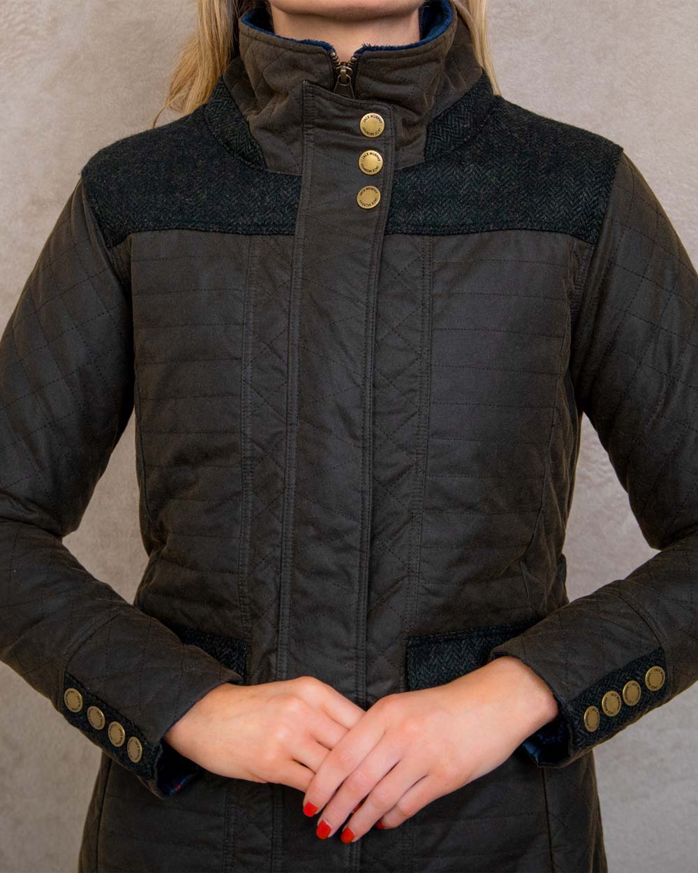 Olive coloured Jack Murphy Jodie Wax Coat on Pastel background