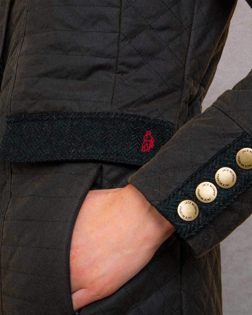 Olive coloured Jack Murphy Jodie Wax Coat on Pastel background