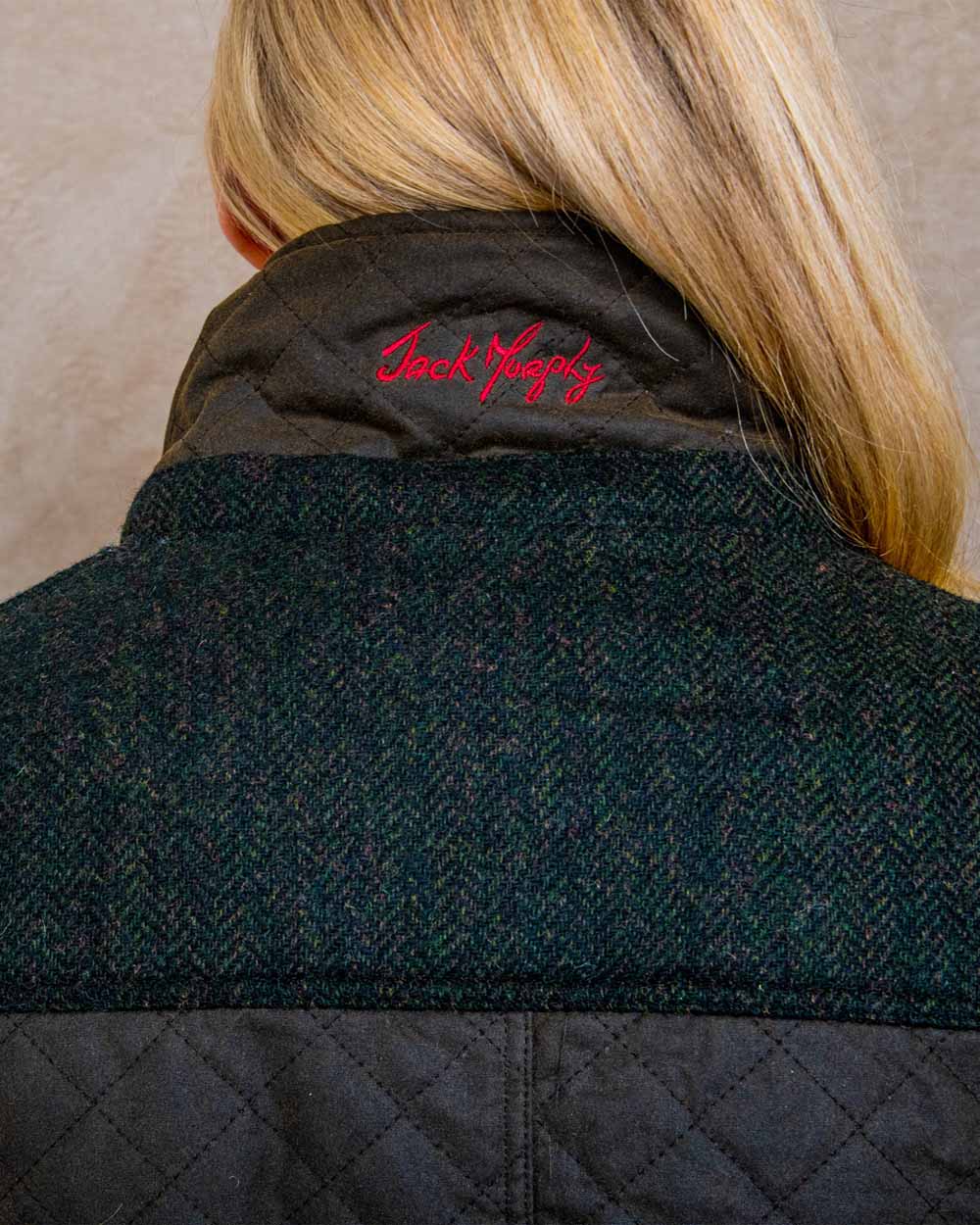 Olive coloured Jack Murphy Jodie Wax Coat on Pastel background