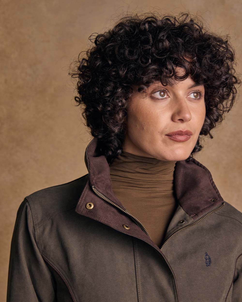 Olive coloured Jack Murphy Una 3/4 Waterproof Coat on wall background